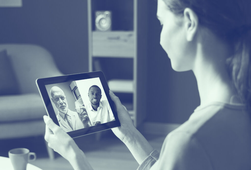 A patient using a tablet to access Video Remote Interpreting to speak with her doctor